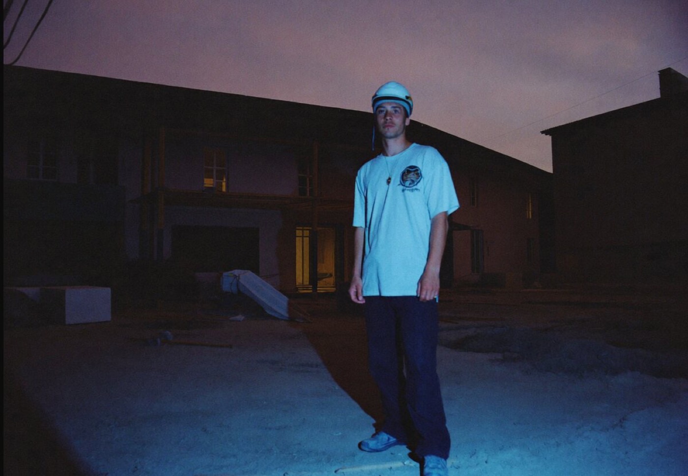 Contractor standing in front of a house at dusk